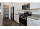 Modern kitchen with stainless steel appliances, gray countertops, and a view into a large pantry at 600 N Carriage Hill Dr # 2174, Las Vegas, NV 89138