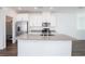 Modern kitchen with stainless steel appliances, white cabinets, and gray countertops with a center island at 600 N Carriage Hill Dr # 2174, Las Vegas, NV 89138