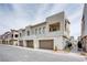 Stylish townhouses line street with individual garages and inviting exterior design at 600 N Carriage Hill Dr # 2174, Las Vegas, NV 89138