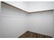 A walk-in closet with installed wood clothing rods at 600 N Carriage Hill Dr # 2174, Las Vegas, NV 89138