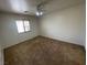 A carpeted bedroom with a window offering natural light and a ceiling fan at 601 Cabrillo Cir # 970, Henderson, NV 89015