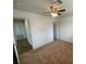 Bedroom with neutral carpet, ceiling fan, and two entryways to the hallway at 601 Cabrillo Cir # 970, Henderson, NV 89015