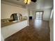 Open-concept living area with tiled floors, fireplace, kitchen, and a sliding door to the balcony at 601 Cabrillo Cir # 970, Henderson, NV 89015