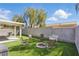 The backyard has artificial grass, a charming fire pit, and a covered patio for outdoor enjoyment at 6312 Monarch Creek St, Las Vegas, NV 89130