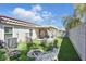 Backyard features artificial turf, an outdoor fire pit and a covered patio for entertaining at 6312 Monarch Creek St, Las Vegas, NV 89130