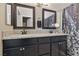 Bathroom features a dual sink vanity with granite countertop and dark wood cabinetry at 6312 Monarch Creek St, Las Vegas, NV 89130