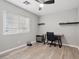 Bedroom featuring desk, ceiling fan, and large window offering ample natural light at 6312 Monarch Creek St, Las Vegas, NV 89130
