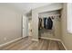Empty bedroom featuring an open closet and doorway to an adjacent bathroom at 6312 Monarch Creek St, Las Vegas, NV 89130