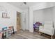 Bright bedroom featuring hard wood floors, a rocking chair and ample closet space at 6312 Monarch Creek St, Las Vegas, NV 89130