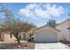 Charming single-story home featuring a low-maintenance landscape and an attached two-car garage at 6312 Monarch Creek St, Las Vegas, NV 89130