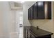 Hallway features dark wood cabinets and drawers with an open doorway to a bedroom at 6312 Monarch Creek St, Las Vegas, NV 89130