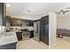 Modern kitchen with stainless steel appliances, granite countertops, and dark wood cabinets at 6312 Monarch Creek St, Las Vegas, NV 89130