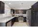 Bright kitchen featuring stainless steel appliances, granite countertops, and ample cabinet space at 6312 Monarch Creek St, Las Vegas, NV 89130