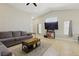 Comfortable living room featuring tile flooring, neutral walls, and a large sectional sofa at 6312 Monarch Creek St, Las Vegas, NV 89130