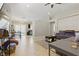 Spacious living room boasts neutral walls and tile floors, seamlessly connected to the dining area at 6312 Monarch Creek St, Las Vegas, NV 89130