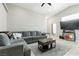 Inviting living room with vaulted ceiling, tile floors, and a comfortable sectional sofa at 6312 Monarch Creek St, Las Vegas, NV 89130