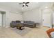 Spacious living room showcasing tile flooring, vaulted ceilings, and an inviting, oversized sofa at 6312 Monarch Creek St, Las Vegas, NV 89130