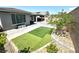 Backyard showcasing artificial turf, brick pavers, and minimal landscaping at 6436 Linden St, North Las Vegas, NV 89086