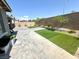A Backyard featuring brick pavers, artificial turf, minimal landscaping, and a privacy wall at 6436 Linden St, North Las Vegas, NV 89086