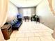 Bright bonus room with a futon sofa, tile floors, and plenty of space for hobbies at 6436 Linden St, North Las Vegas, NV 89086