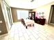 Cozy dining room featuring white tile floors, slider to the patio, and dark wood furniture at 6436 Linden St, North Las Vegas, NV 89086