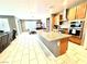 Open kitchen with island, stainless appliances, and eat-in dining with plenty of natural light at 6436 Linden St, North Las Vegas, NV 89086