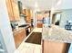 Open kitchen with granite countertops, light maple cabinets, and stainless steel appliances at 6436 Linden St, North Las Vegas, NV 89086