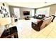 Open-concept living room featuring tile flooring, plenty of light, and comfortable leather seating at 6436 Linden St, North Las Vegas, NV 89086