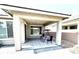 Covered patio with a swing and chairs, lighting and brick pavers at 6436 Linden St, North Las Vegas, NV 89086