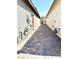 Wide side yard with brick pavers running between two buildings at 6436 Linden St, North Las Vegas, NV 89086