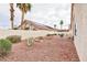 A low-maintenance backyard featuring desert landscaping and a stone accent at 672 Hitchen Post Dr, Henderson, NV 89011