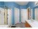 Bathroom showcasing walk-in shower, adjacent storage, and single sink vanity at 672 Hitchen Post Dr, Henderson, NV 89011