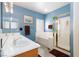 Bright bathroom with dual sinks, a separate shower, and a luxurious soaking tub at 672 Hitchen Post Dr, Henderson, NV 89011