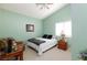 Cozy bedroom featuring a vaulted ceiling, a comfortable chair, and a large window at 672 Hitchen Post Dr, Henderson, NV 89011