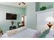 This bedroom features a ceiling fan, TV, and closet at 672 Hitchen Post Dr, Henderson, NV 89011