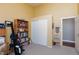 Bedroom area with sliding door closet, neutral carpet and decor, and doorway to another room at 672 Hitchen Post Dr, Henderson, NV 89011