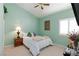 Inviting bedroom features a ceiling fan and a cozy bed with decorative pillows at 672 Hitchen Post Dr, Henderson, NV 89011