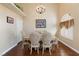 Elegant dining area with hardwood floors, a chandelier, and seating for six at 672 Hitchen Post Dr, Henderson, NV 89011