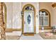 Close-up of an elegant front door with an oval window and decorative accents at 672 Hitchen Post Dr, Henderson, NV 89011