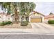 Charming single-story home with a well-manicured yard and mature landscaping at 672 Hitchen Post Dr, Henderson, NV 89011