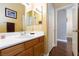 Well-lit half bathroom with a modern sink, wood cabinetry, and updated fixtures at 672 Hitchen Post Dr, Henderson, NV 89011