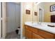 Cozy half bathroom featuring wooden cabinets, a stylish mirror, and neutral walls at 672 Hitchen Post Dr, Henderson, NV 89011