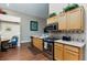 Kitchen with stainless steel appliances, granite countertops and tile backsplash, and hardwood floors at 672 Hitchen Post Dr, Henderson, NV 89011