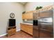 Kitchen with stainless steel refrigerator, wood cabinets, granite countertops, and hardwood floors at 672 Hitchen Post Dr, Henderson, NV 89011