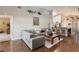 Spacious living room with high ceilings, hardwood floors and skylight, open to kitchen and breakfast bar at 672 Hitchen Post Dr, Henderson, NV 89011