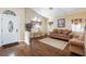 Comfortable living room featuring hardwood floors, large windows, and stylish furnishings at 672 Hitchen Post Dr, Henderson, NV 89011