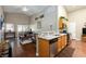 Open floor plan featuring granite kitchen counter opening up into living area with vaulted ceilings at 672 Hitchen Post Dr, Henderson, NV 89011