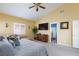 Spacious bedroom featuring a vaulted ceiling, large windows, and plush carpeting at 672 Hitchen Post Dr, Henderson, NV 89011