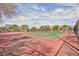 Community tennis courts with green and red surfacing surrounded by chain link fence at 672 Hitchen Post Dr, Henderson, NV 89011