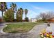 Lush backyard featuring a well-manicured lawn, mature trees, and decorative rock landscaping at 6860 Stubblefield Dr, Pahrump, NV 89061